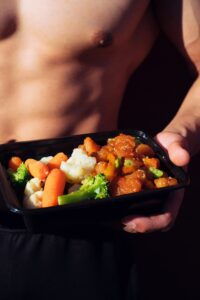 Healthy and fit man holding a plate