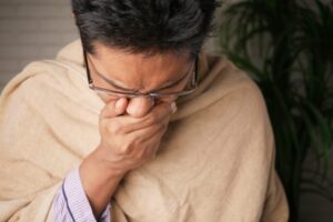man sneezing with flu - HealthMed.org